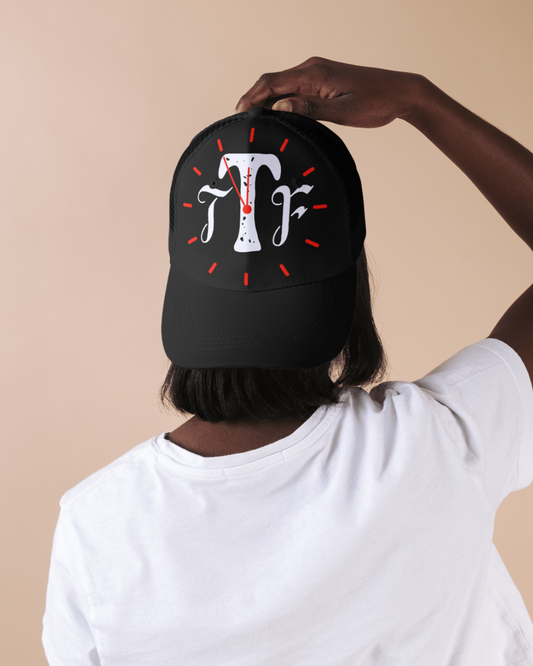 Person wearing a black cap with a logo on a beige background